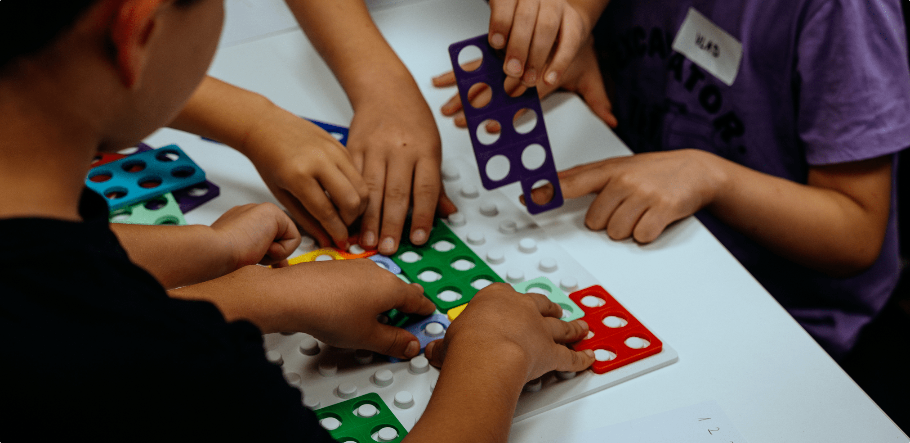 The students are putting together a puzzle. 