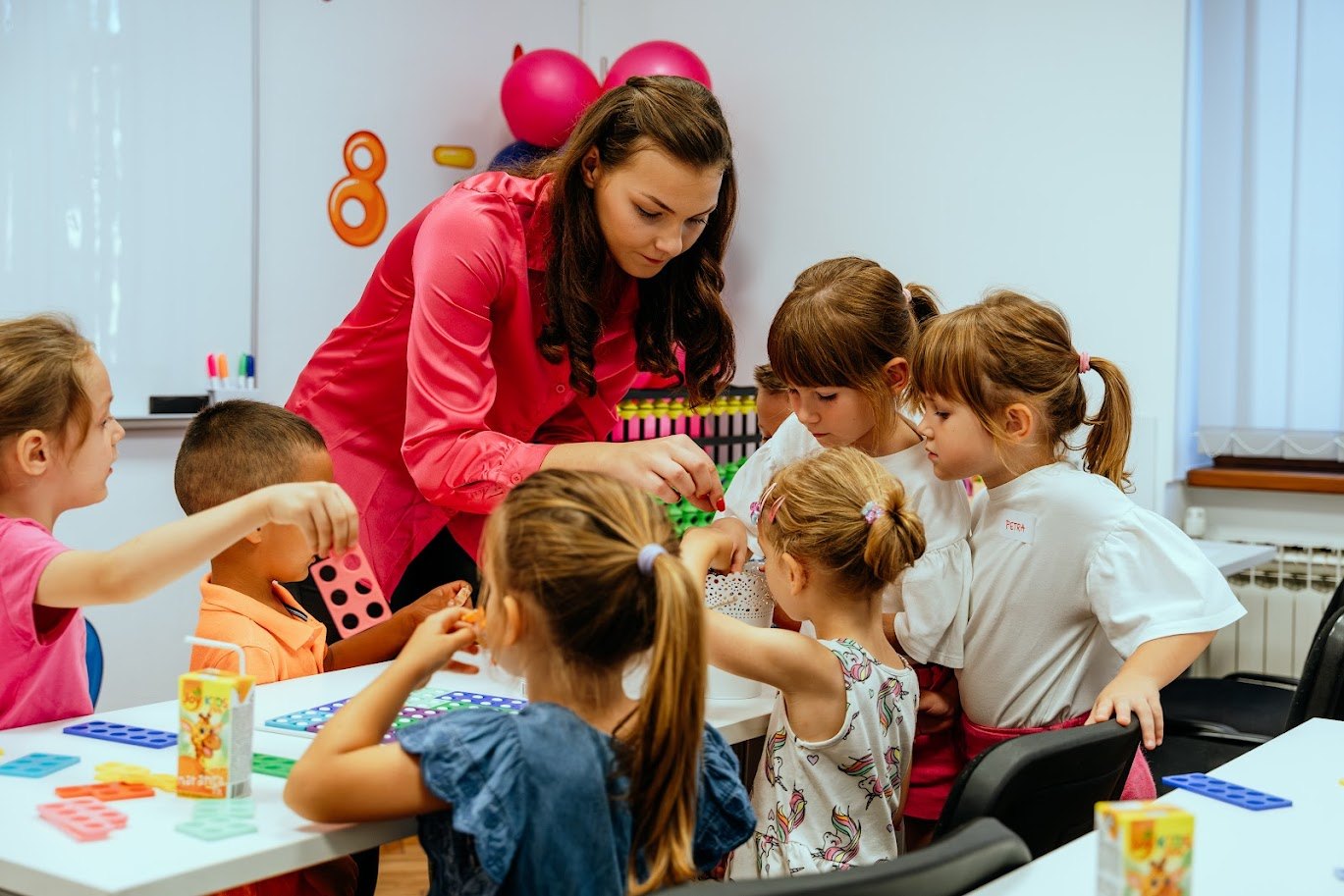 The teacher and students are playing games together.