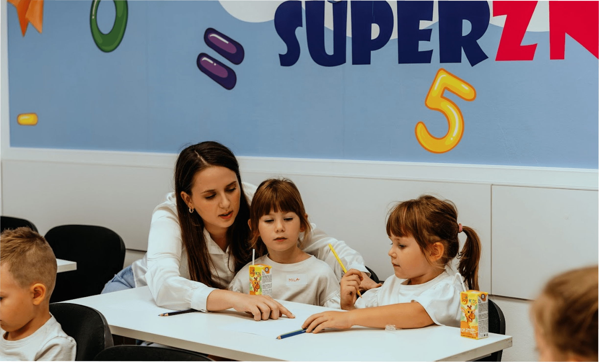 The teacher is explaining in detail the process of solving tasks and learning.