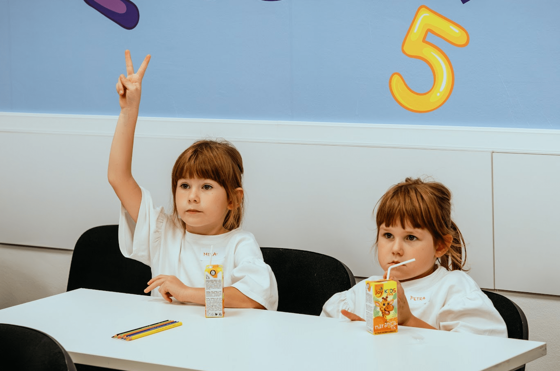 The student signals to the class that she wants to share her answer with everyone.
