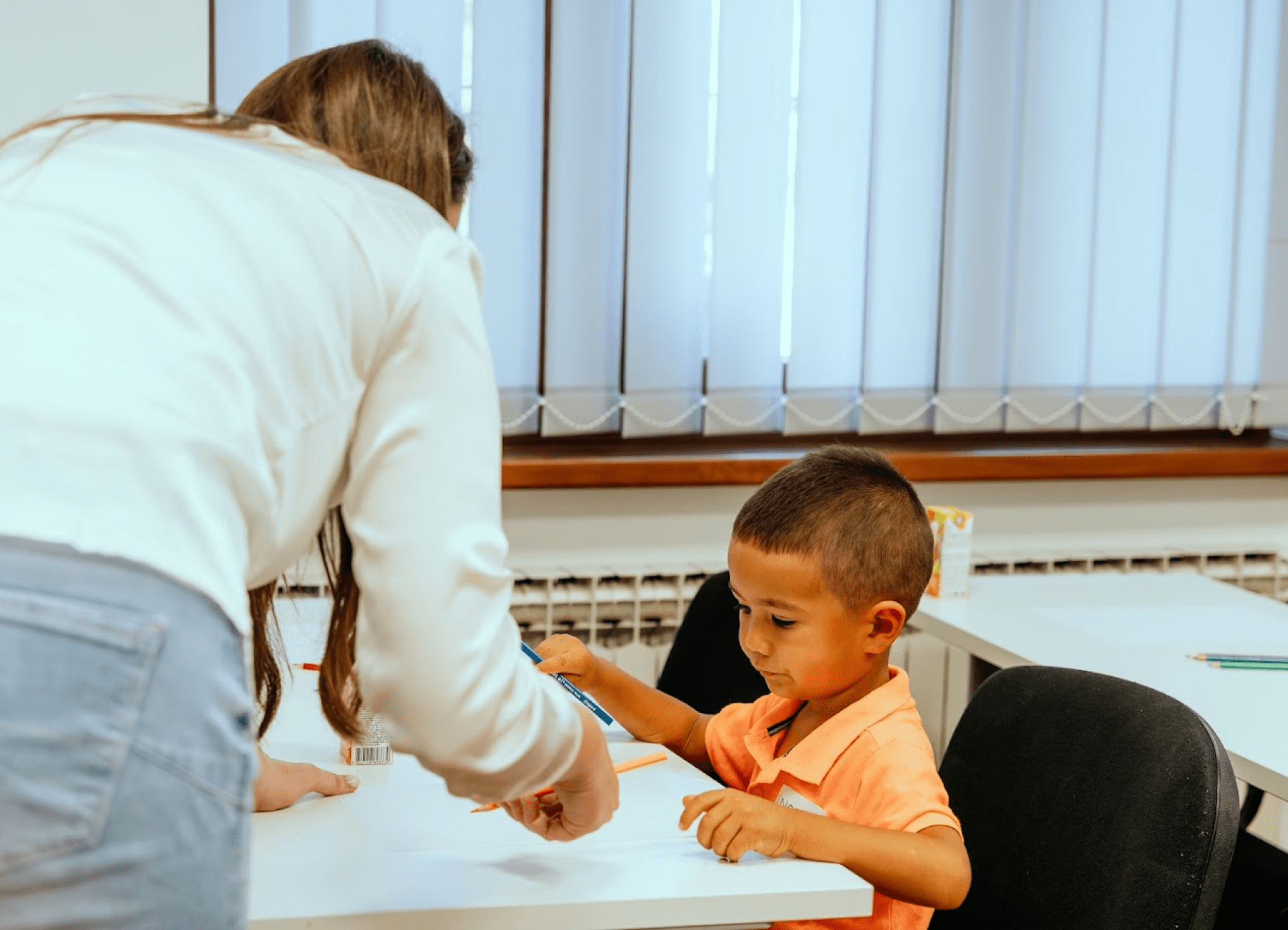 The teacher is explaining the task to the student.