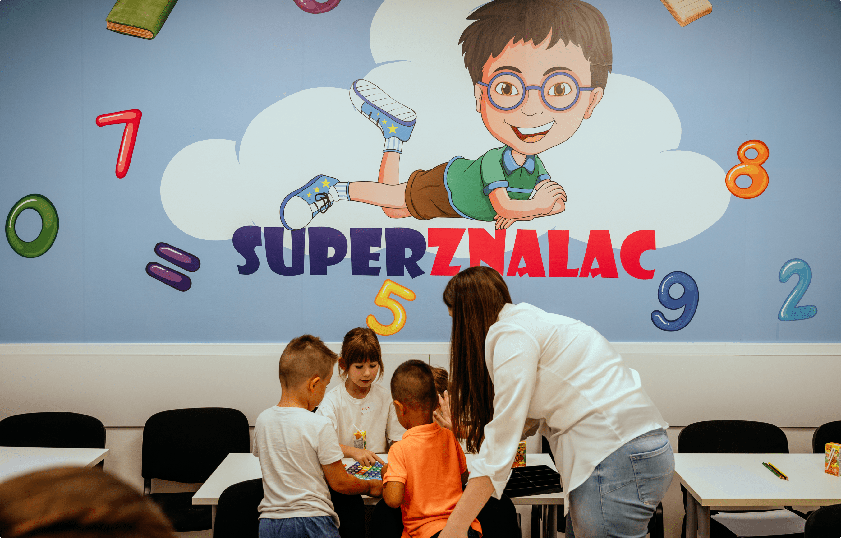 A classroom with children and a teacher.
